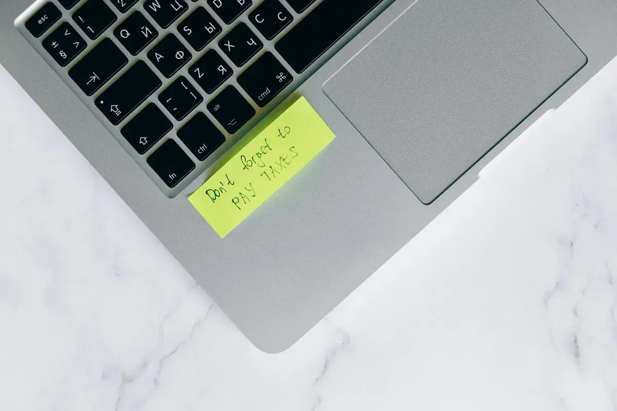 Tax preparation documents and calculator on a desk
